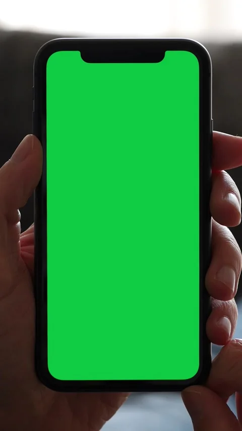 Single Tapping and Holding a Green Screen Smartphone on the Couch at Home Video stock 284110457