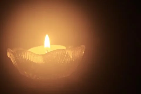Single tea light candle in the dark Stock Photos