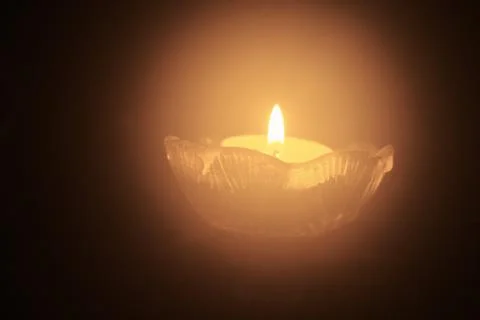Single tea light candle in the dark Stock Photos