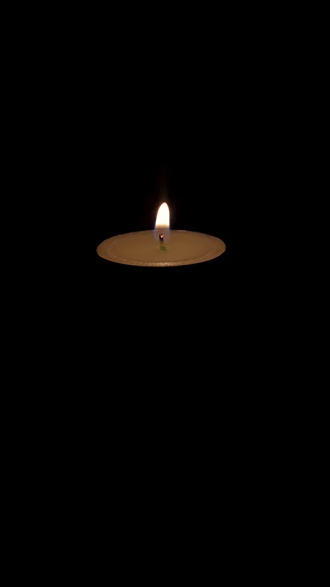 Single Tealight Candle Flame Flickering in Darkness, Vertical Composition Stock Footage 345272447