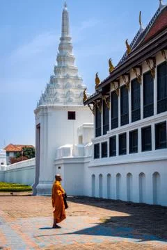 Single Thai monk praying in front of Grand Palace Stock Photos
