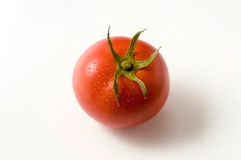 Single Tomato with Stem Isolated on White Background. Top view. Tomato is con Stock Photos