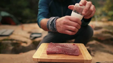 Single tourist cooks beef steak Stock Footage 258643667