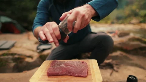 Single tourist cooks beef steak Stock Footage 258643861