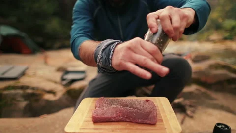 Single tourist cooks beef steak Stock Footage 258643868