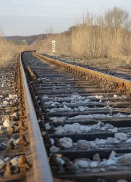 Single track railway line. Empty straight single-way railway line at sunny day Stock Photos