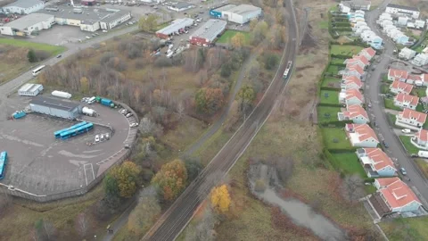 Single Tram Running Though Suburb, Villas and Industrial Area, Aerial Vídeos de archivo 147095623