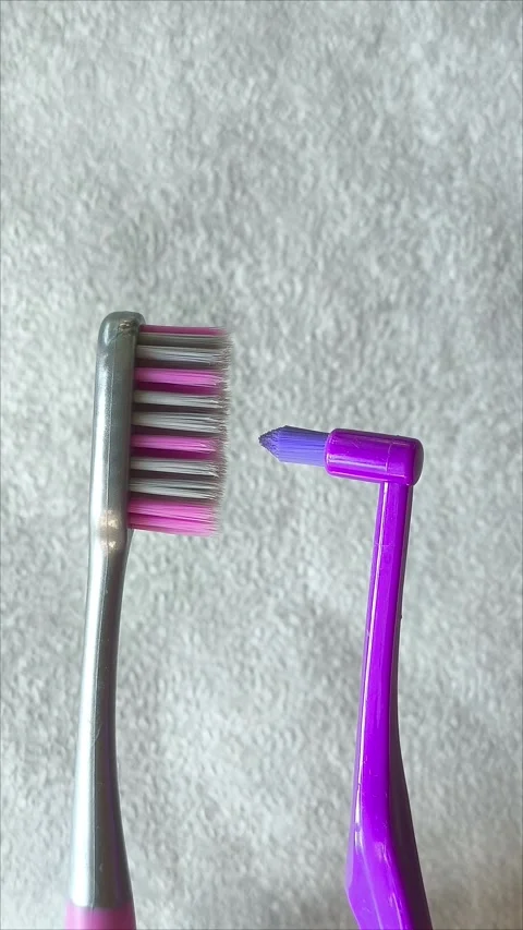 Single tuft brush and a toothbrush on a gray background Видео 313356379