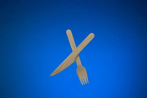 Single use disposable and biodegradable wooden knife and fork. Close up studi Stock Photos