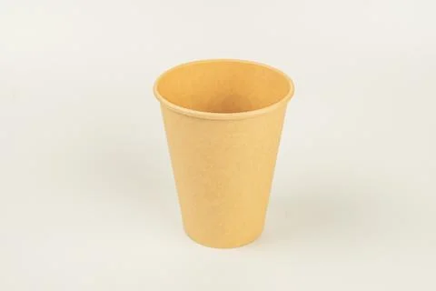 A single-use, glossy paper cup for serving beverages like coffee or tea, comm Stock Photos