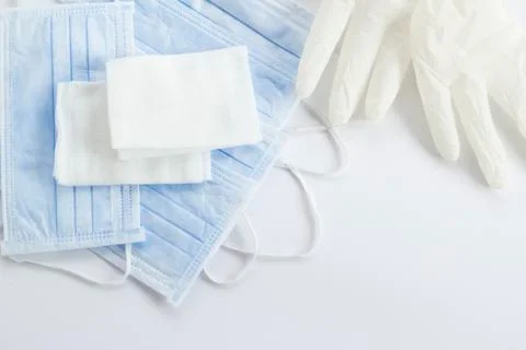 Single use hygenic face mask,sterile gauze pads and gloves on white Stock Photos