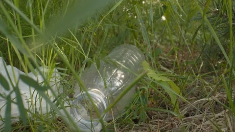 Single use plastic waste in nature | Stock Video | Pond5
