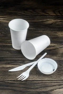Single-use white plastic items on table Fotos de archivo