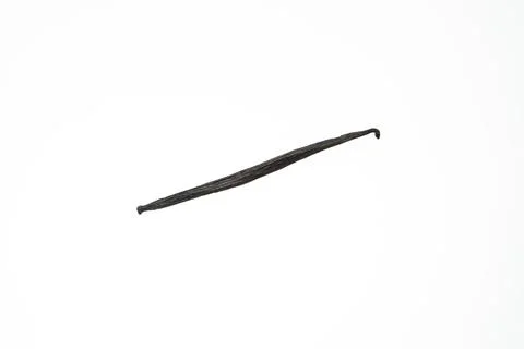 Single vanilla bean pod isolated on white background studio shot Fotos de archivo