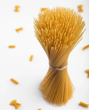 Single Vertical Bundle of Raw Spaghetti Pasta on White Background Foto stock