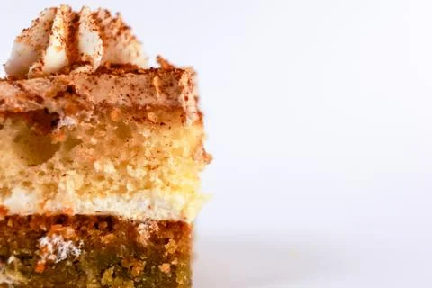 Single vertical slice of layered cake with whipped cream frosting between sponge Stock Photos