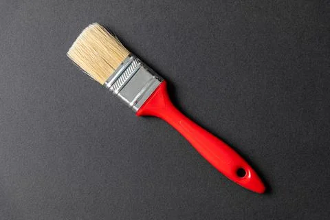 Single wall paint brush on black stone background Stock Photos