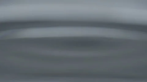 A Single Water Drop Creating Ripples in a Glass Stock Footage 208784754