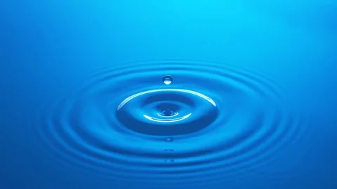 Single Water Drop - Low Impact - Blue Water Surface - Slow Motion Stock Footage