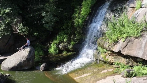 Single Waterfall Over Boulders with Audio Stock Footage 126964273