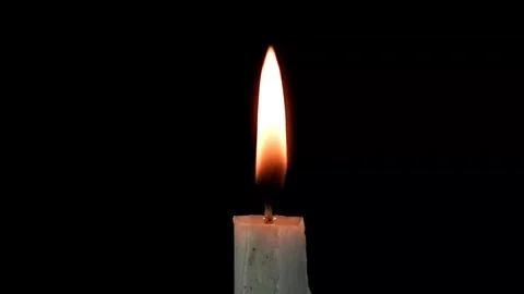 A single white candle burning brightly in the dark Stock Footage 320290755