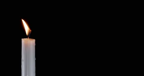 A single white candle burning. Isolated candle slow motion burning with dark Stock Footage 236222860