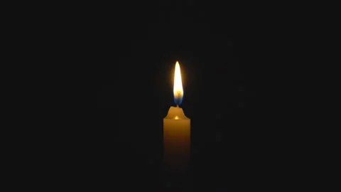 A single white candle burning. Looping for use as a background or illustration Video stock 112559319