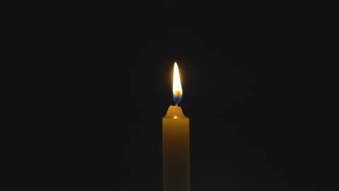 A single white candle burning. Looping for use as a background or illustration Stock Footage 112559354