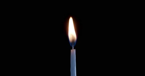 A single white candle burning.Isolated candle burning with dark background.White Stock Footage 144986781