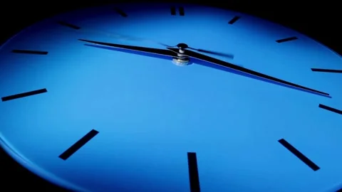 Single white clock hanging on wall time lapse cinematic concept of film Stock Footage 336445057