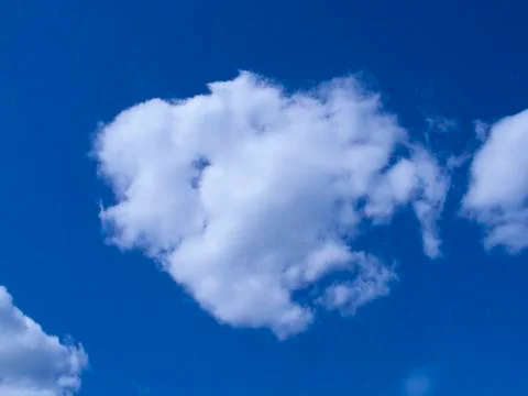 Single white cloud in the blue sky Stock Photos