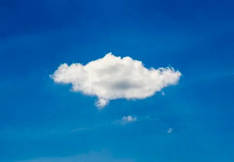 Single white cloud in the blue sky Stock Photos
