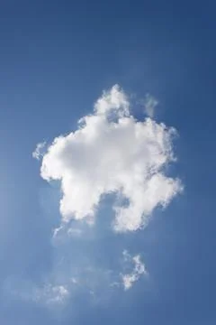 Single white cloud on the blue sky Stock Photos