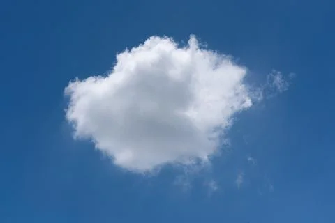 A single white cloud delicately floating against a calm blue sky Stock Photos