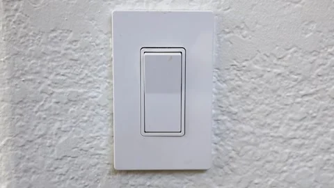 Single White Light Switch on White Wall Turning On and Off With Fingeri Stock Footage 248701238
