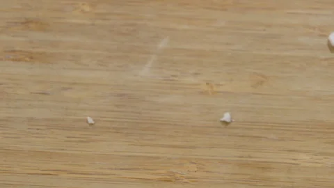 Single White Pill or Supplement on Wooden Surface Closeup Stock Footage 340245006
