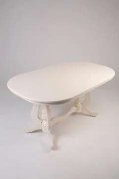 Single white round table with empty surface and carved legs on an isolated Stock Photos