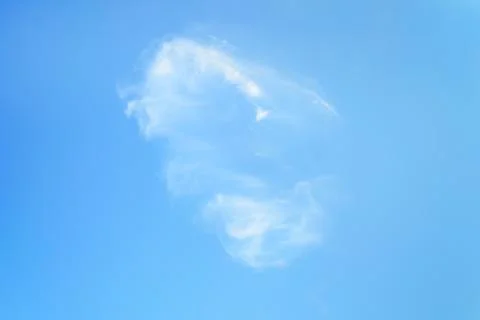 Single white translucent cirrus cloud high in the blue summer sky. Stock Photos