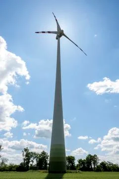 Single wind power engine against the sun Stock Photos