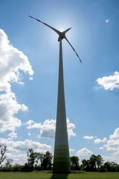 Single wind power engine against the sun Stock Photos