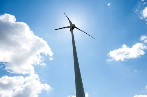 Single wind power engine with clouds and sky Stock Photos