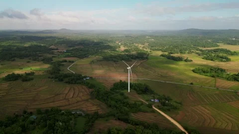 Single Wind Turbine Amidst Rolling Farmlands on Guimaras Island - aerial flyover Vídeos de archivo 334577084
