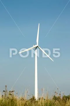Single wind turbine with blue sky Stock Photos