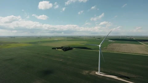 Single wind turbine captured from the air with dramatic cloud formations and Stock Footage 337255328