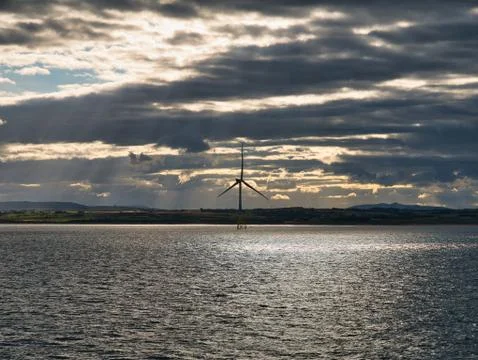 A single wind turbine off the coast of Aberdeen Stock Photos