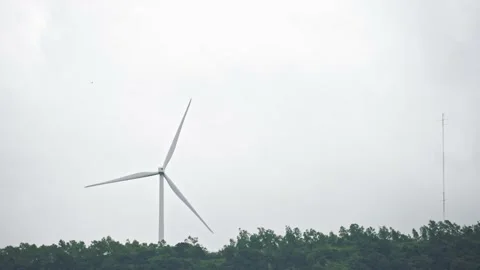 A single wind turbine on mountain edge Stock Footage 222143920