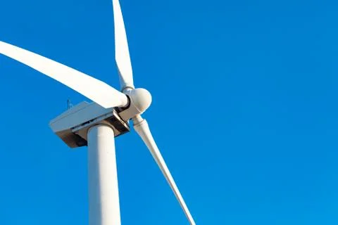 Single Wind Turbine Over Dramatic Blue Sky. Stock Photos