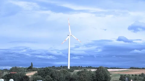 Single Wind Turbine Rotating Above Rural Farmland Stock Footage 346038894