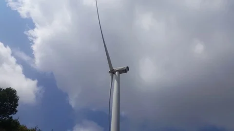A Single Wind Turbine Spinning Stock Footage 79734312