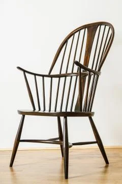 Single Windsor style chair in empty room Stock Photos